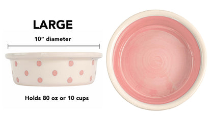 Large pink handmade ceramic dog and cat bowl with large hand-painted dots, solid pink interior, 10-inch diameter, and 10-cup (80-ounce) capacity.