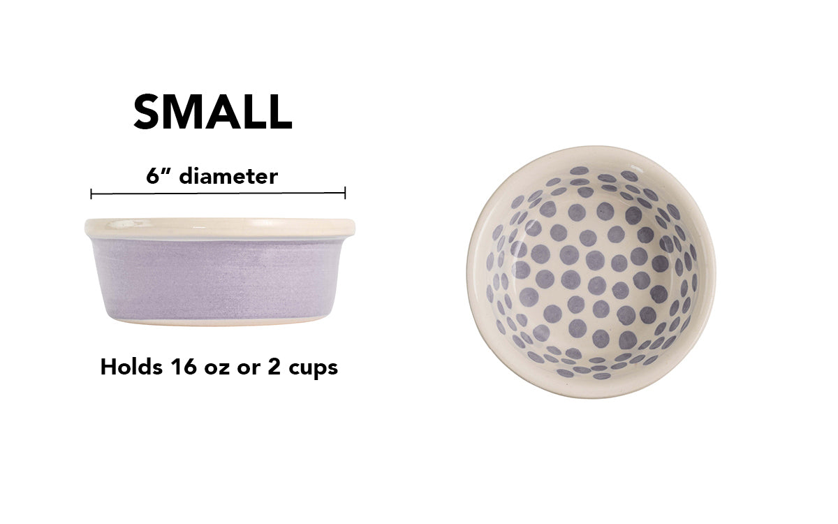Small lavender handmade ceramic dog bowl with lavender polka dots inside, rich lavender color-washed exterior and white rim, 6-inch diameter and 2-cup (16-ounce) capacity.