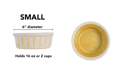 Small yellow handmade ceramic dog and cat bowl with yellow vertical drip details around the white exterior, glossy yellow interior and white rim, 6-inch diameter and 2-cup (16-ounce) capacity.