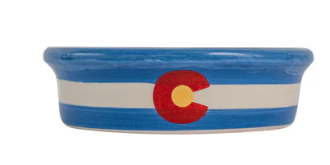 Blue handmade ceramic dog and cat bowl with minimalist Colorado state flag design around the outside, featuring a white stripe and red C with gold center.