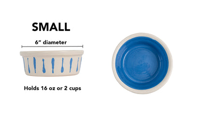Small blue handmade ceramic dog and cat bowl with blue vertical drip details around the white exterior, glossy blue interior and white rim, 6-inch diameter and 2-cup (16-ounce) capacity.