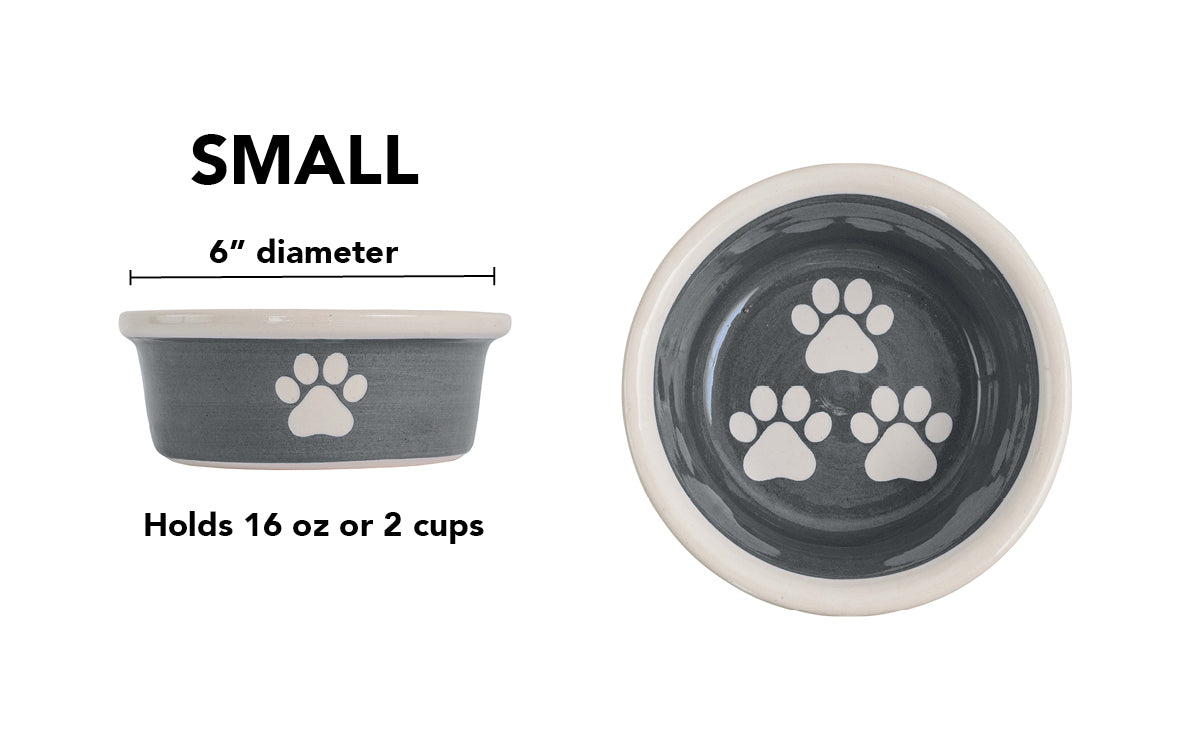 Small charcoal gray handmade ceramic dog bowl with white paw prints, 6-inch diameter and 2-cup (16-ounce) capacity.