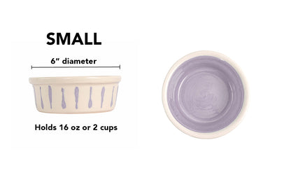 Small lavender handmade ceramic dog and cat bowl with lavender vertical drip details around the white exterior, glossy lavender interior and white rim, 6-inch diameter and 2-cup (16-ounce) capacity.