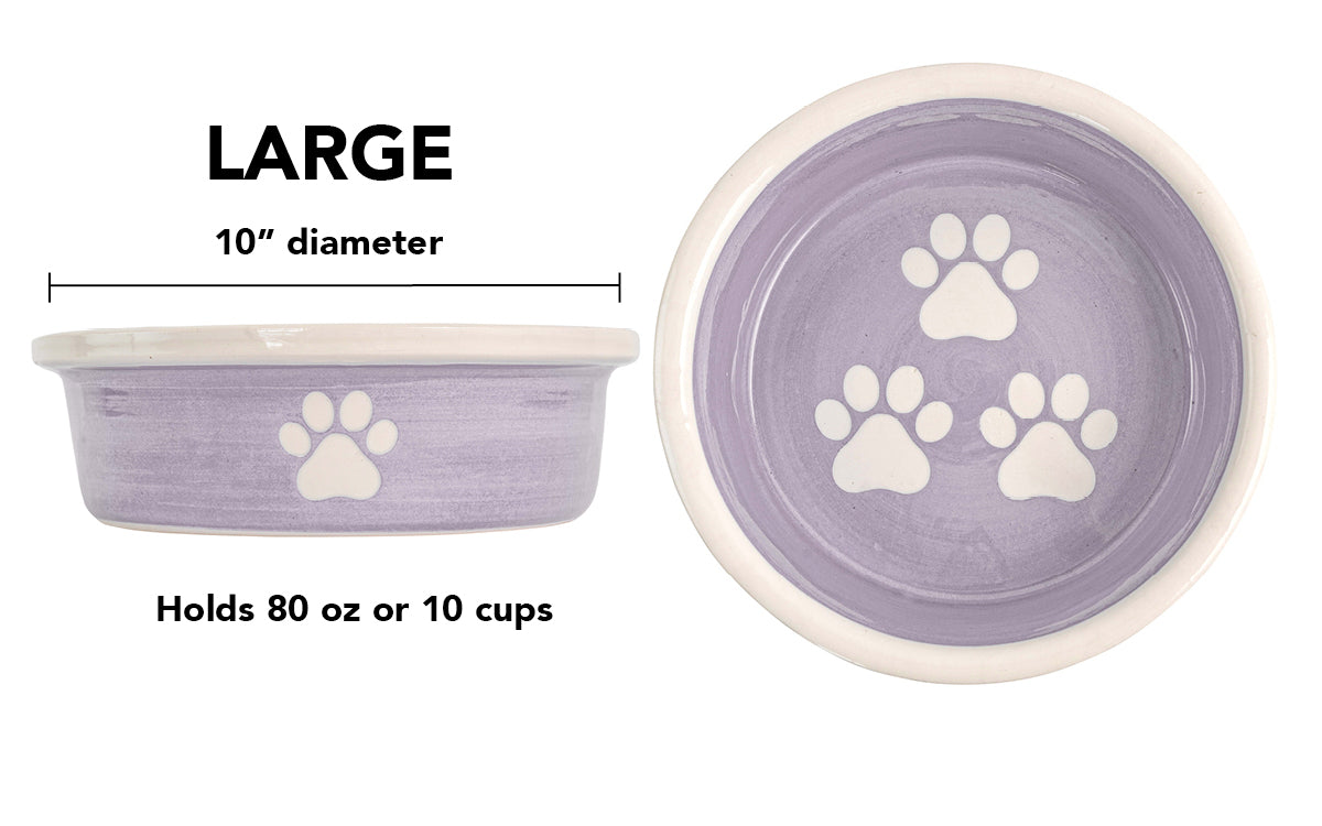 Large lavender handmade ceramic dog bowl with white paw prints, 10-inch diameter and 10-cup (80-ounce) capacity.