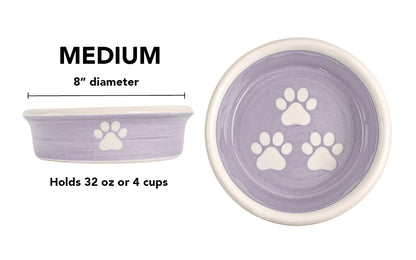 Medium lavender handmade ceramic dog bowl with white paw prints, 8-inch diameter and 4-cup (32-ounce) capacity.