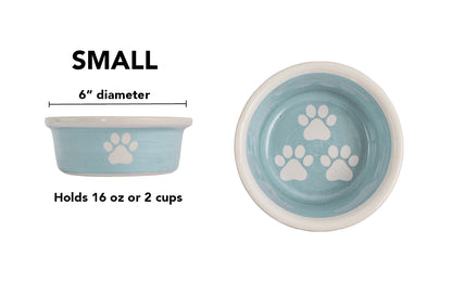 Small sky blue handmade ceramic dog bowl with white paw prints, 6-inch diameter and 2-cup (16-ounce) capacity.