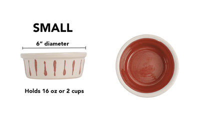 Small terracotta handmade ceramic dog and cat bowl with terracotta vertical drip details around the white exterior, glossy terracotta interior and white rim, 6-inch diameter and 2-cup (16-ounce) capacity.