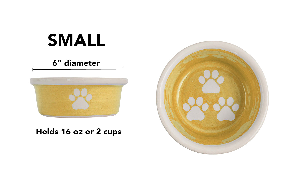Small yellow handmade ceramic dog bowl with white paw prints, 6-inch diameter and 2-cup (16-ounce) capacity.